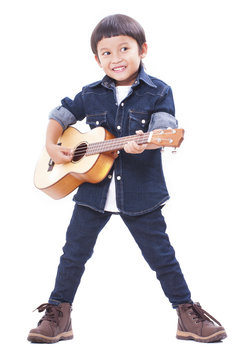 Cute boy playing the ukulele on white background 