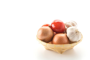 tomatoes, onion and garlic in basket