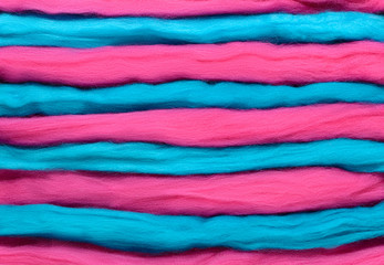 Turquoise and pink horizontal stripes. Background made of wool for felting.