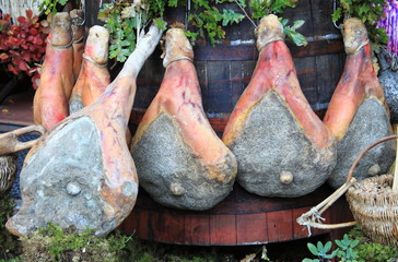 Parma Ham hanging in a delicatessen shop in Italy