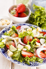 Strawberry salad with cucumber, red onion and parmesan cheese
