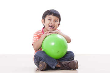 Fototapeta premium Little boy playing green ball 