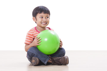 Fototapeta premium Little boy playing green ball 