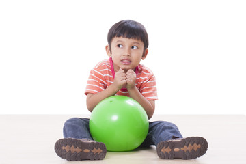 Fototapeta premium Little boy playing green ball 