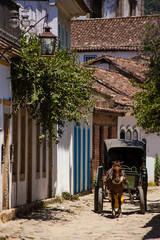 Fototapeta na wymiar A wain in historical street with old church tower - Paraty - RJ