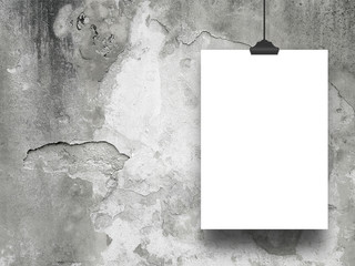 Close-up of one hanged paper sheet frame with clip on weathered concrete wall background - obrazy, fototapety, plakaty