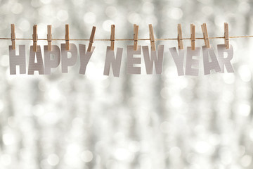 Happy new year - paper letters on bokeh background