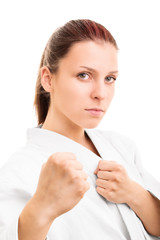 Young girl with the fists up isolated on white background