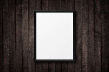 Blank black picture frame on the grunge wood texture. background