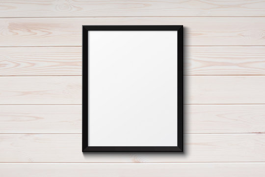 Blank black picture frame on the grunge wood texture