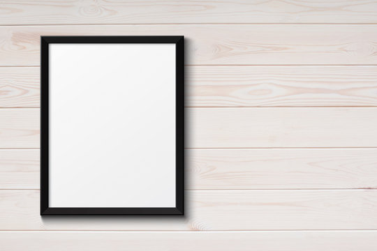 Blank black picture frame on the grunge wood texture