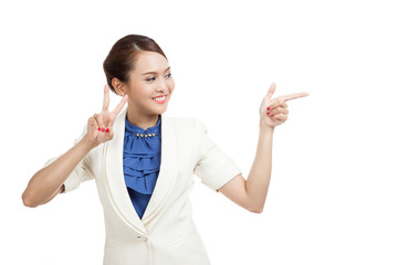 Young Asian business woman show victory sign point to space