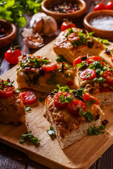 Homemade focaccia with tomatoes, sun-dried tomatoes, mozzarella