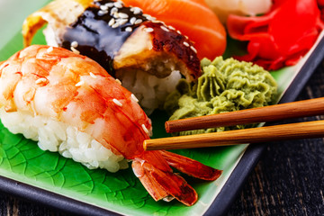 The composition of nigiri sushi with  shrimp, eel, salmon, butte
