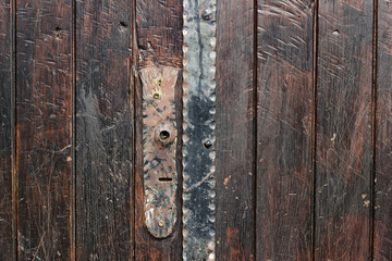 Old rustic wooden door with iron detail