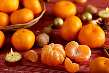 Ripe mandarins on a red wooden table