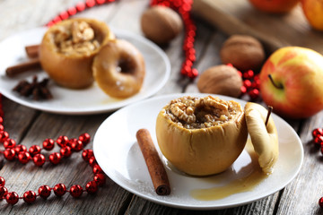 Baked apples on plate on grey wooden table