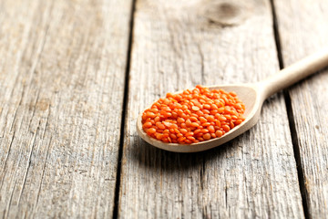 Red lentils on a grey wooden table