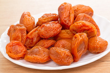Dried apricots on a white plate