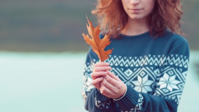 Girl holding an autumn  leaf
