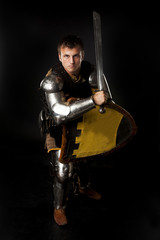 Young knight in defense position