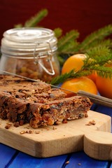 Homemade vegan fruit cake with oranges and glass jar decorated w