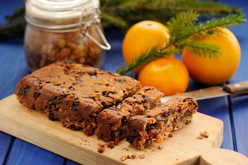 Vegan fruit cake with oranges and glass jar decorated with fir t