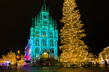 Fototapeta na wymiar The city hall of Gouda in the Netherlands is lighted in several colours during the Christmas holidays.