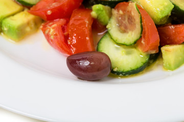 Fresh avocado salad with olives.