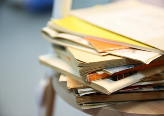 Pile of books on lamp shelf, close up