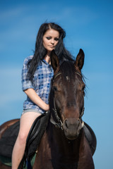 Fototapeta premium Young beautiful girl with a horse on nature