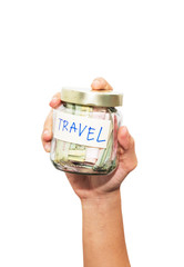 Fototapeta na wymiar Hand holding travel budget , money savings in a glass jar 