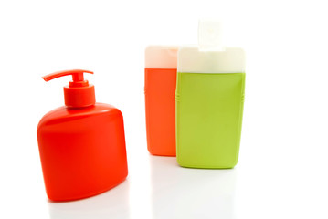 three colored bottles with shower gel