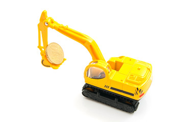 Fototapeta premium euro coin and yellow backhoe