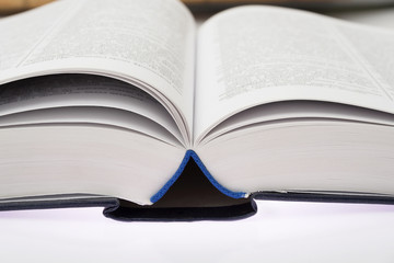 Open book with blue hard cover.