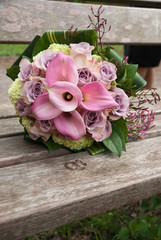 Wedding bouquet with roses on a wooden bench