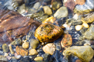 colored stones under water as background