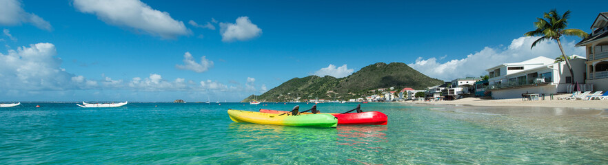 Fototapeta na wymiar Colored Kayaks in a caribbean sea