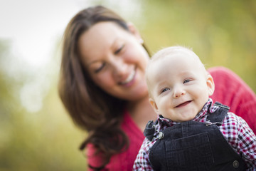 Fototapeta na wymiar Little Baby Boy Having Fun With Mommy Outdoors