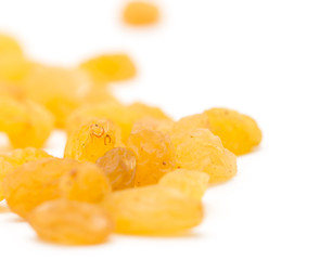 Golden raisins on a white background