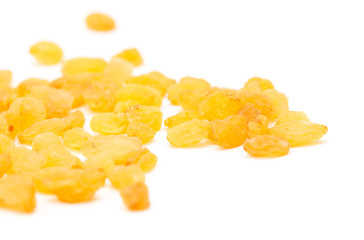 Golden raisins on a white background