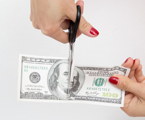 100 dollar cut with scissors on white