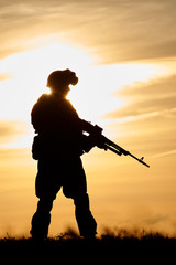 Military soldier silhouette with machine gun 