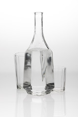 Two glasses and a decanter on grey white background