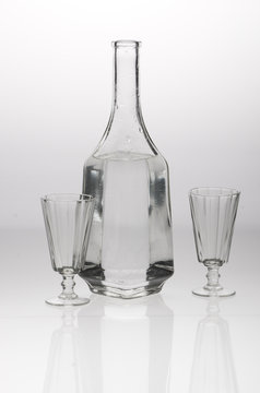 Two glasses and a decanter on grey white background