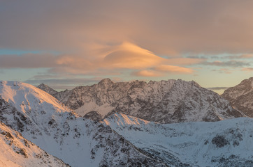 Fototapeta na wymiar Colorful lenticular clouds over High Tatras at winter