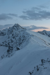 Snowy Swinica mountain in High Tatras in the evening, winter.