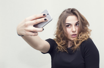 Girl doing self phone on a white background