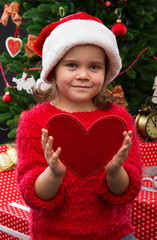 Portrait of a little girl holding red heart