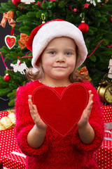 Portrait of a little girl holding red heart